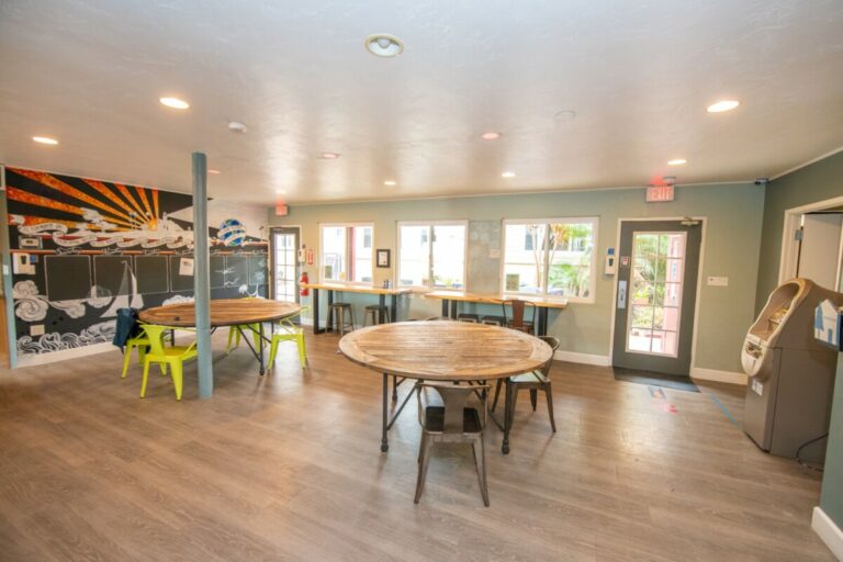 Tables and common area in Ocean Beach Hostel