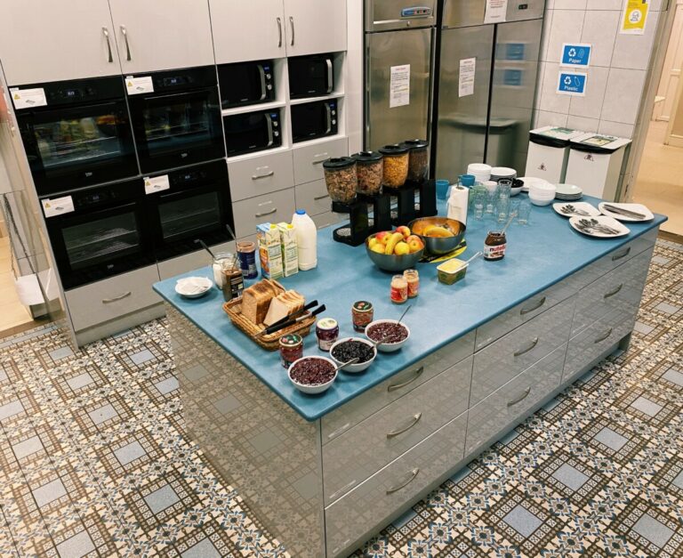 Bird's eye view of kitchen with food at Canbe Hostels - Gardiner House