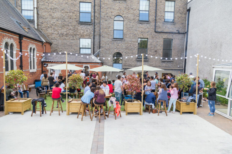 Outside gathering with tables and lights at Canbe Hostels - Gardiner House