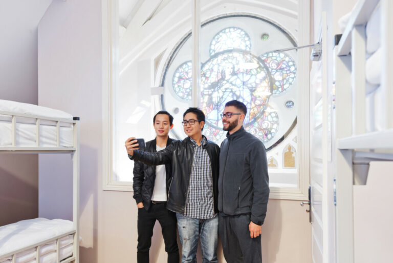 Three travellers taking a selfie near the window at Canbe Hostels - Gardiner House