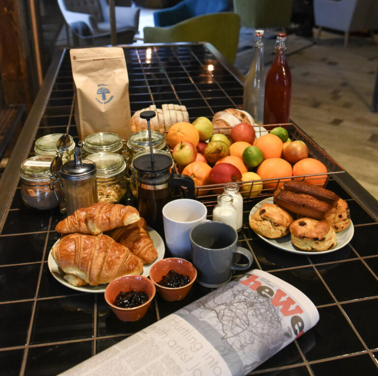 Breakfast and fruit spread with croissants and jams at The Nest Boutique Hostel Galway