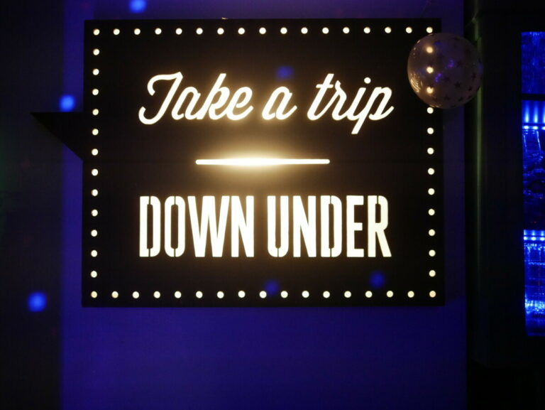 Sign "Take a trip down under"