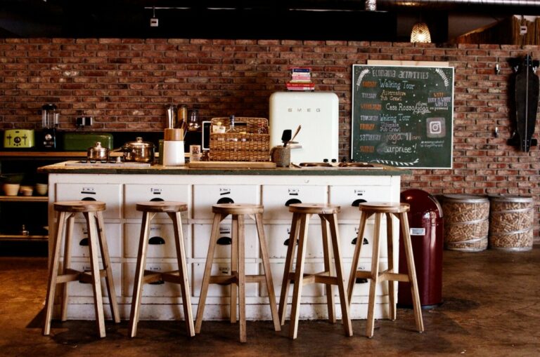 Kitchen with island and stools at Cocomama hostel