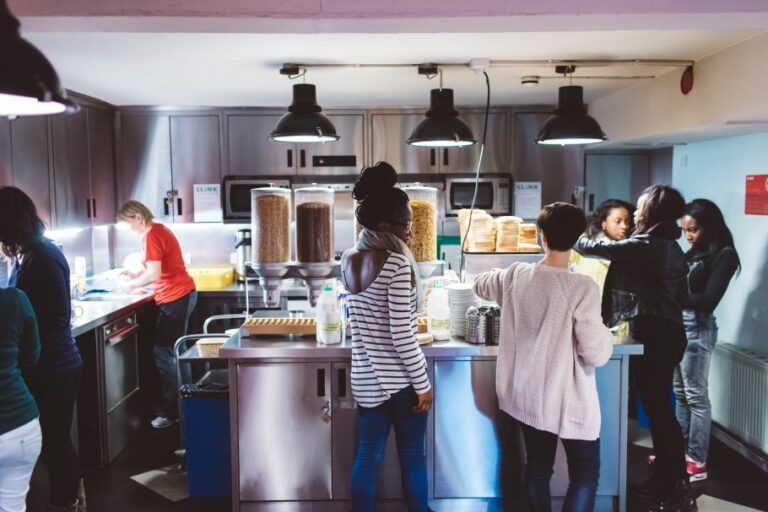 People in kitchen at Clink261 getting food