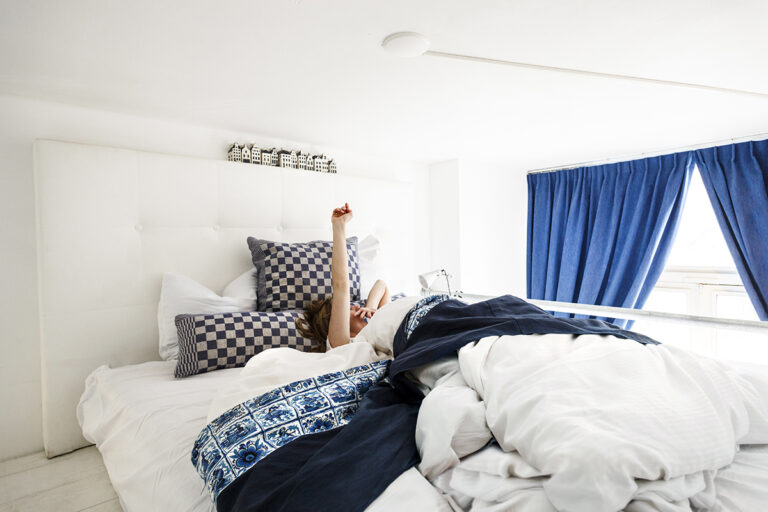 Guest waking up in a private room in Amsterdam hostel Cocomama